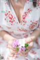 A woman holding a bunch of flowers in her hands.