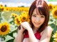 A woman in a field of sunflowers posing for a picture.