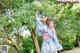 A woman in a blue and white kimono holding an umbrella.