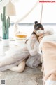 A woman laying on a bed with a sleeping mask on.