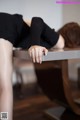 A woman laying on top of a wooden table.