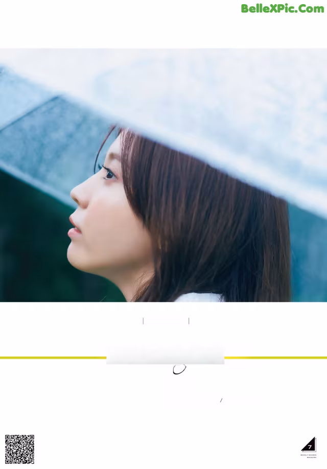 A woman with long brown hair is looking away from the camera.