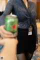 A woman holding a can of soda in her hand.