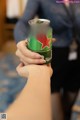 A person holding a can of Heineken beer in their hand.